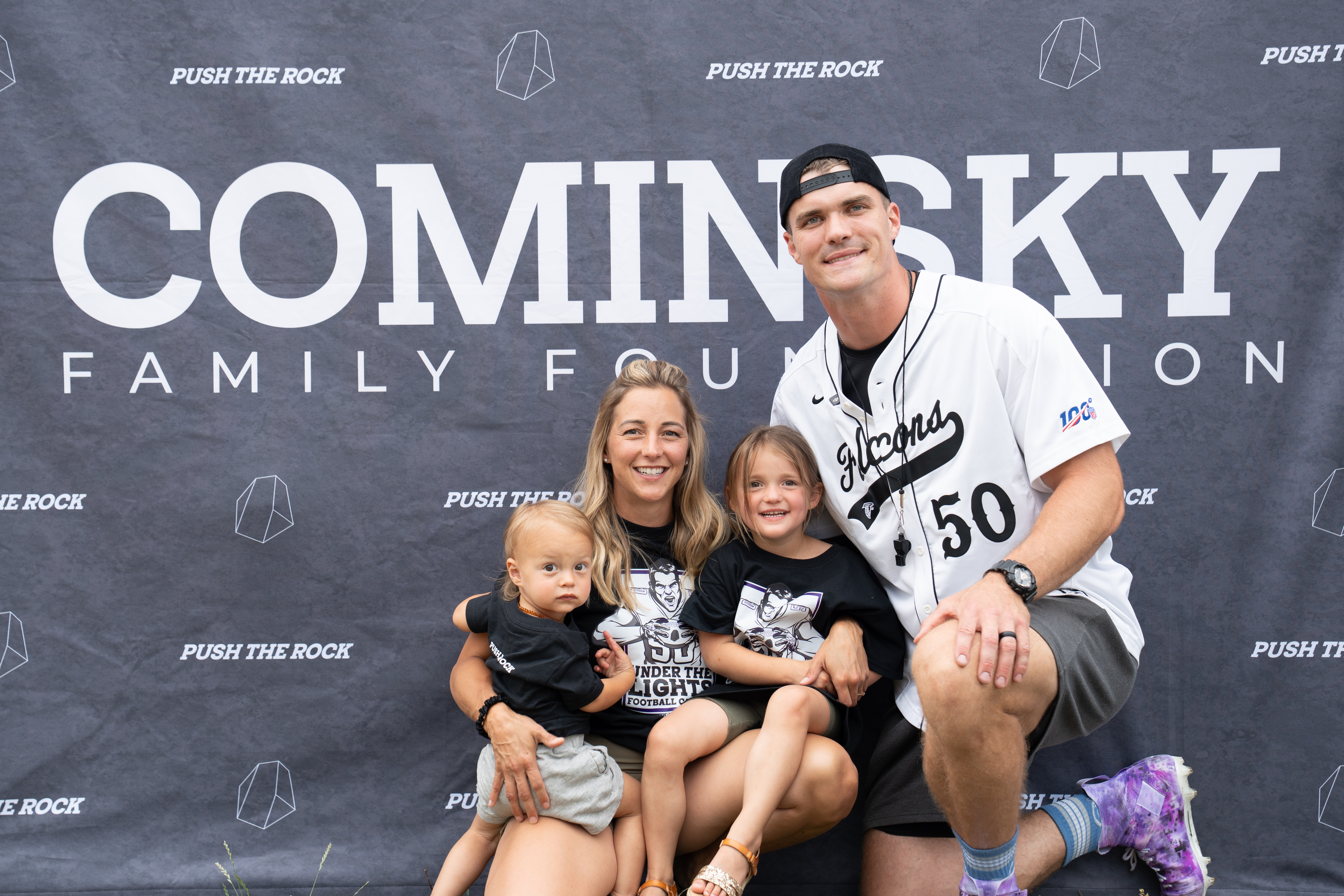 John, Brittany and the Cominsky kids in front of the Foundation backdrop