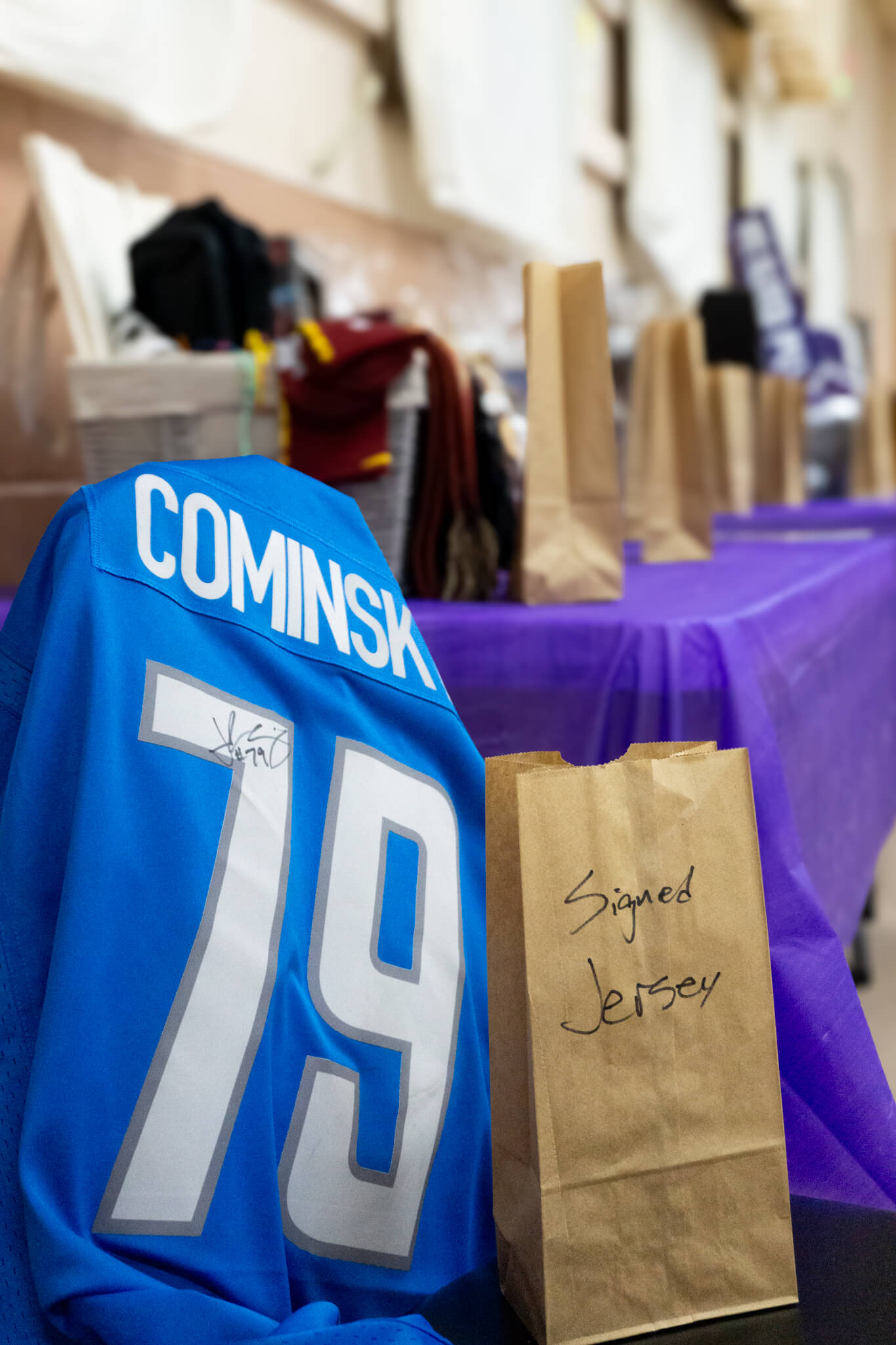 Signed John Cominsky jersey displayed at a foundation event