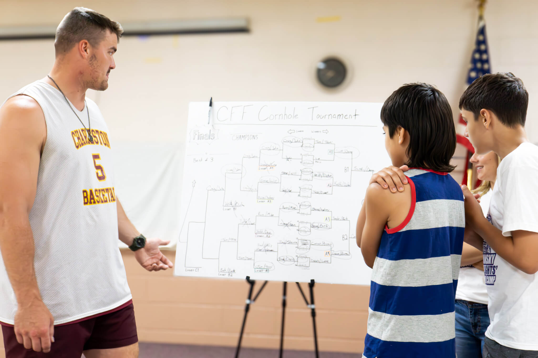 John Cominsky posing with a young football camp participant