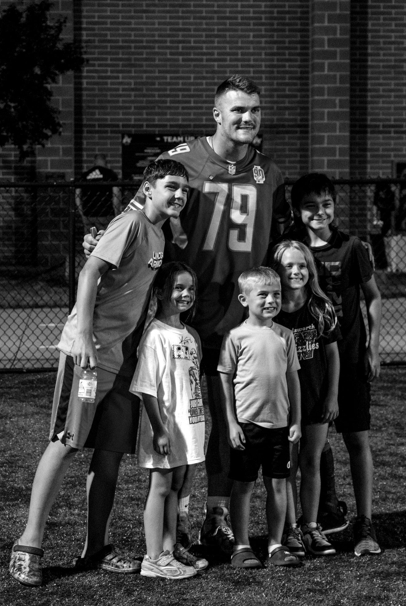 John with young fans after camp